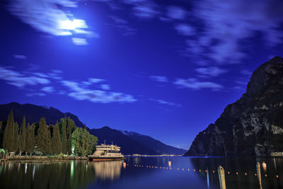 Scenic view of lake against sky at night