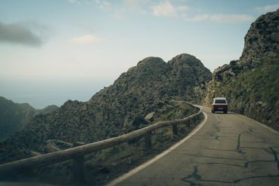 Van moving on road towards mountains