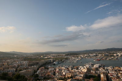 High angle view of townscape by sea against sky