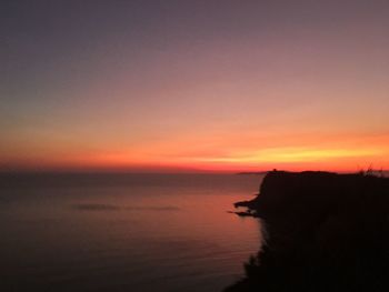 Scenic view of sea against romantic sky at sunset