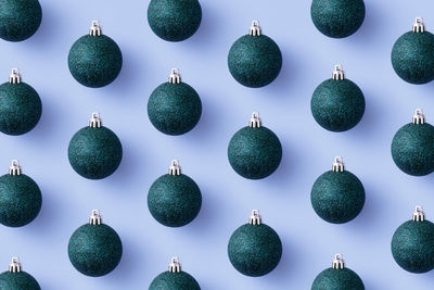 Low angle view of decorations hanging against blue sky