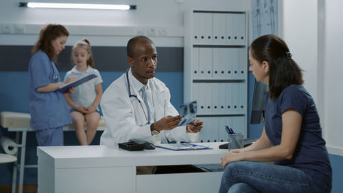 Doctor showing medical x-ray at clinic