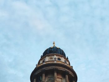 Low angle view of neue kirche against cloudy sky