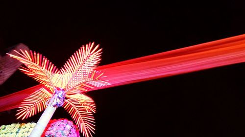 Low angle view of illuminated ferris wheel