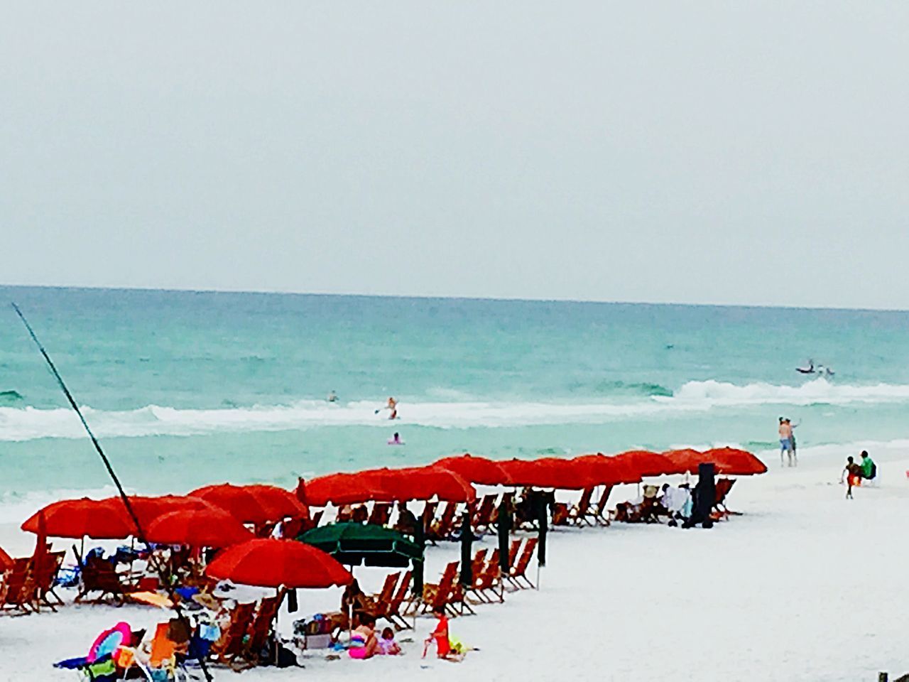 horizon over water, sea, beach, clear sky, water, copy space, tranquility, scenics, tranquil scene, beauty in nature, nature, vacations, shore, beach umbrella, sand, parasol, red, incidental people, sky, sunshade