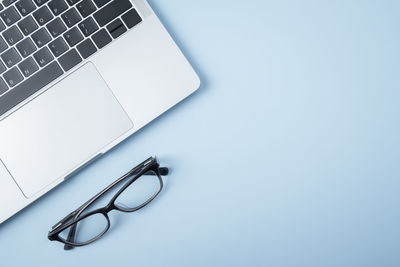 Close-up of eyeglasses on table against white background