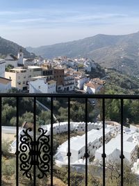 Mirador view over sayalonga and its circular cemetery against the mountains and sky in southernspain