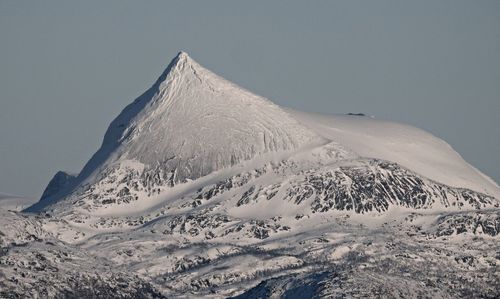 Scenic view of snowcapped mountains against clear sky