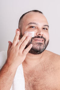 High angle view of senior man drinking water against white background