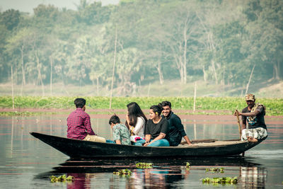 People sitting on boat in water