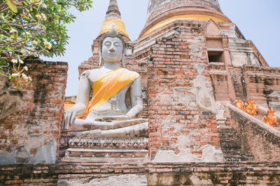 Low angle view of statue against historic building