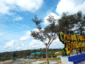 Low angle view of sign board against sky