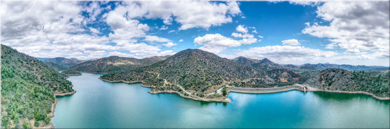 Panoramic view of dam against sky blue sky and clouds