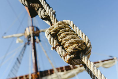 Low angle view of rope tied to pole