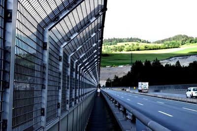 Cars on road in city against clear sky