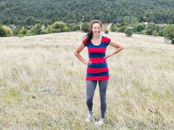 Young, beautiful girl standing in a wheat field in nature