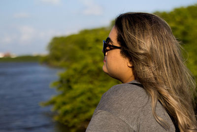 Woman in sunglasses at lakeshore