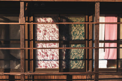 Close-up of glass window hanging on building