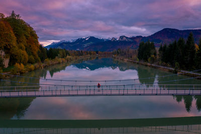 Scenic view of lake by mountains against sky