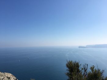 High angle view of sea against clear blue sky