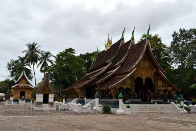 Temple by building against sky