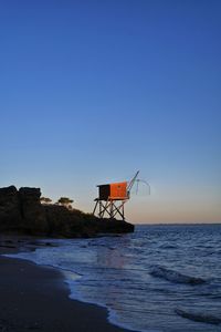 Scenic view of sea against clear blue sky