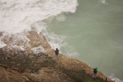High angle view of men fishing in sea