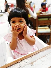 Cute girl sitting on high chair