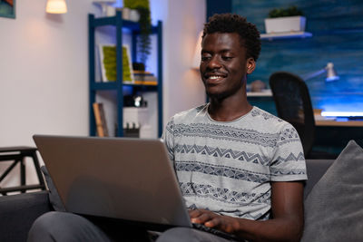 Young man using laptop at home