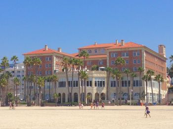 View of buildings against clear blue sky