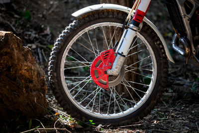 Close-up of bicycle wheel on field