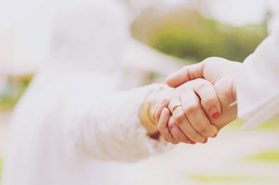 Close-up of couple holding hands