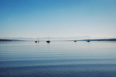 Scenic view of lake against clear blue sky