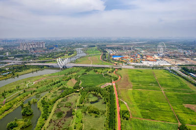 High angle view of agricultural field against sky in city