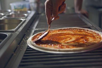Close-up of hand holding pizza