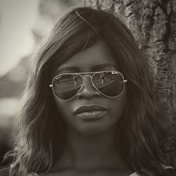 Close-up portrait of woman wearing sunglasses