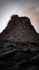 Low angle view of rock formation against sky