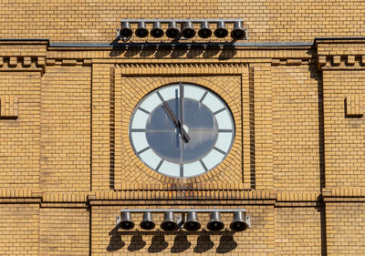 Low angle view of clock tower against building