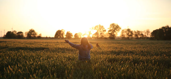 Full length of man on field against sky during sunset