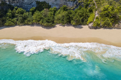 Nusa penida island, kelingking beach. top view aerial view of a sandy clean beach 