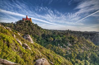 Scenic view of mountains and a colorful palace against sky 