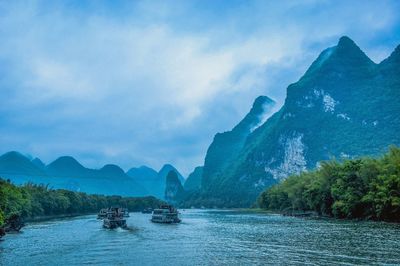 Scenic view of mountains against blue sky