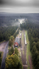 High angle view of road amidst trees against sky
