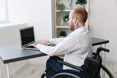 Young man using laptop at home