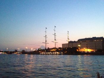 View of illuminated city against sky at sunset