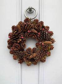 Christmas wreath. elegant charming wreath on a white wooden door. home decoration, xmas festive mood