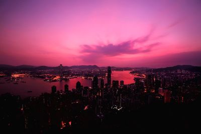 Aerial view of city lit up at sunset