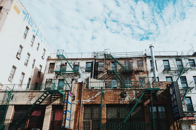 Low angle view of buildings in city against sky