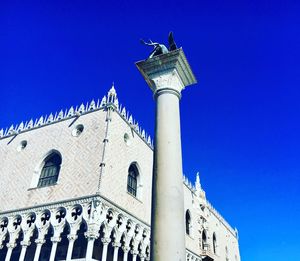 Low angle view of bell tower against blue sky