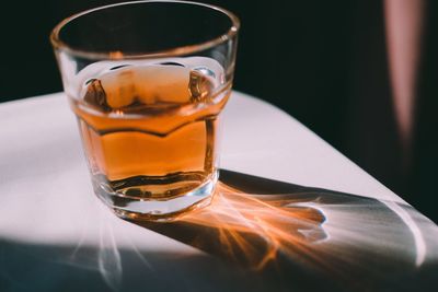 Close-up of whiskey glass on table